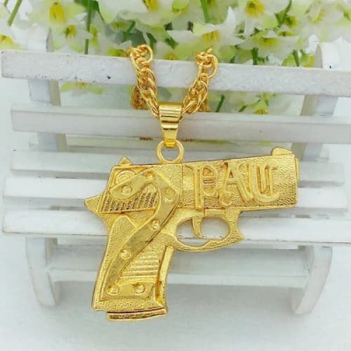 Chunky gold-tone chain necklace with a large gold-tone gun-shaped pendant